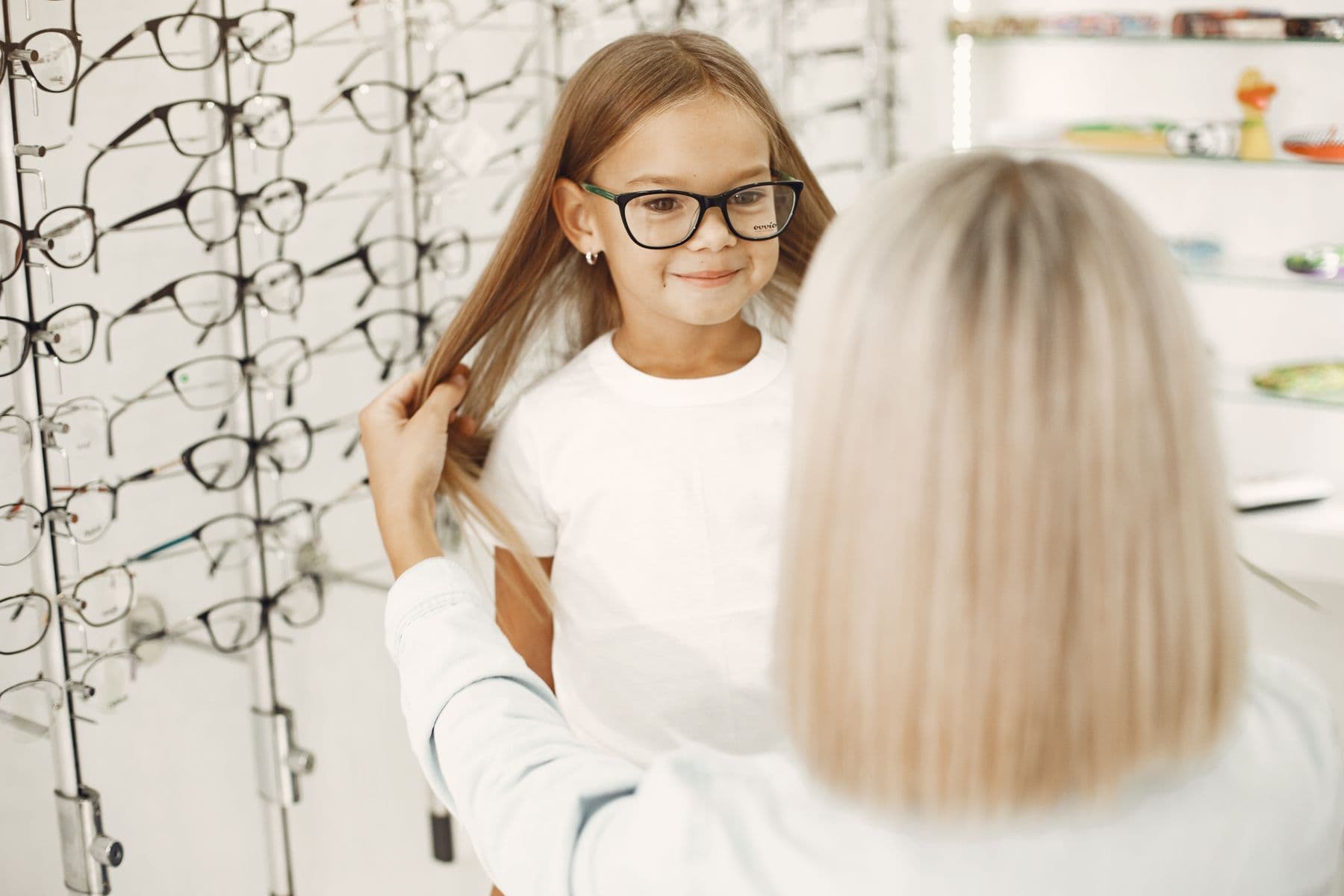 A young girl wearing black glasses