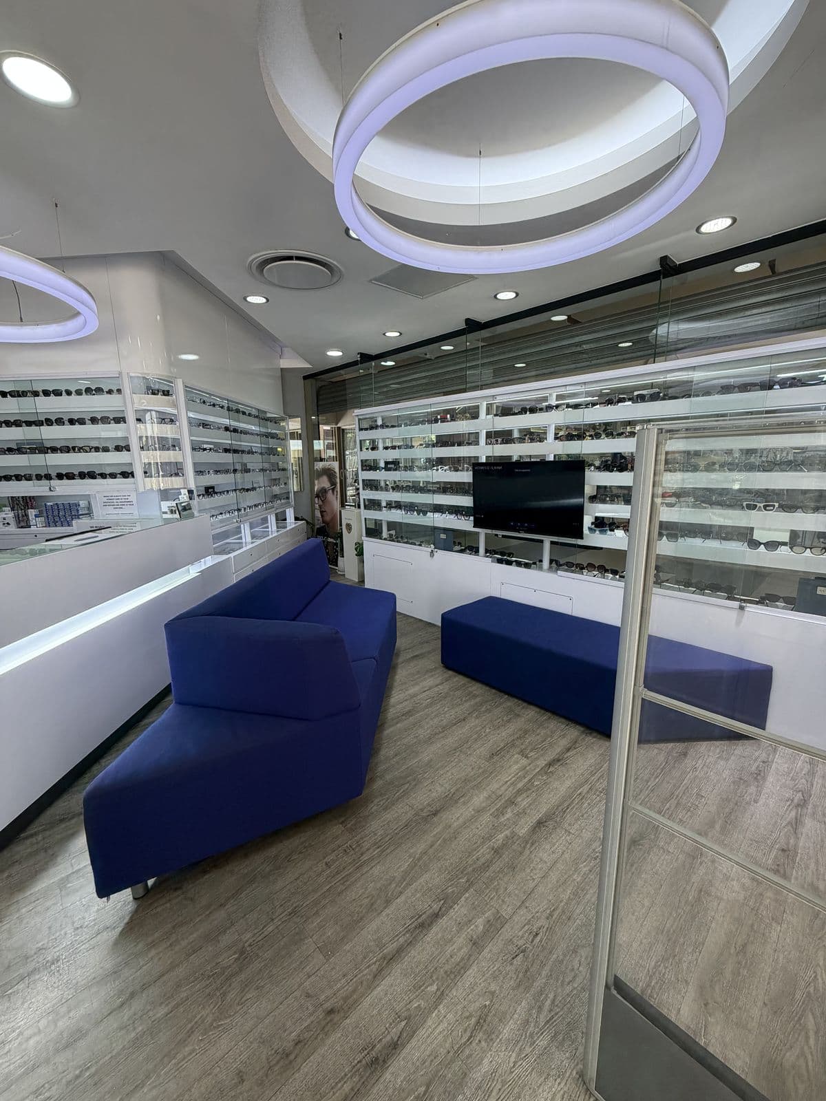 The waiting area with blue sofas at Bryanston Optometrists